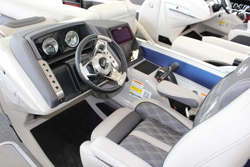 Slide: The Image of 2025 Barletta LUSSO 25U boat interior with modern steering and dashboard controls. - 12