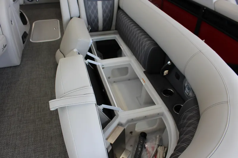 Slide: The Image of 2025 Barletta LUSSO 25U boat interior with open storage compartments and luxurious seating. - 5