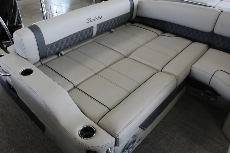 Slide: The Image of 2025 Barletta LUSSO 25U boat interior with luxurious seating and cup holders. - 9