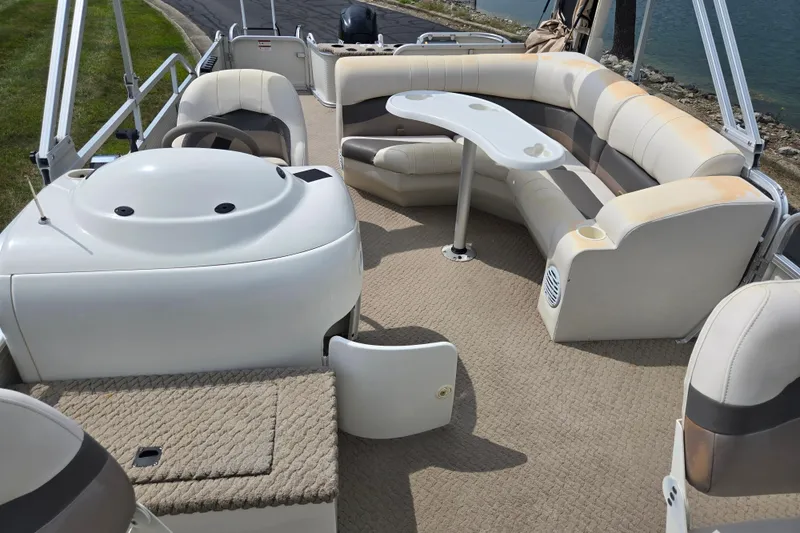 Slide: The Image of Interior of a 2007 Suncruiser Trinidad 204 pontoon boat with seating and table. - 11