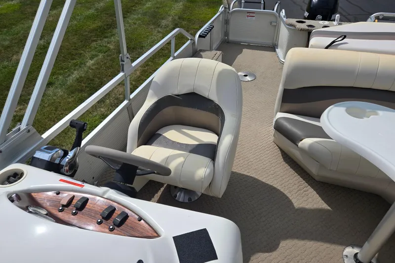 Slide: The Image of Interior of 2007 Suncruiser Trinidad 204 boat with beige seating and control panel. - 17