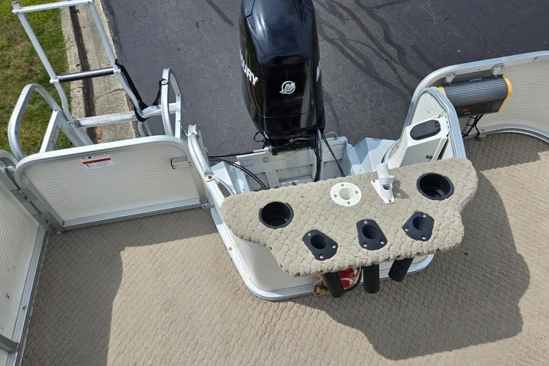 Slide: The Image of 2007 Suncruiser Trinidad 204 boat deck with motor and rod holders. - 19
