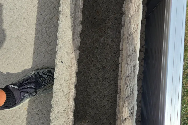 Slide: The Image of A foot on a textured carpeted surface of a 2007 Suncruiser Trinidad 204 boat. - 22