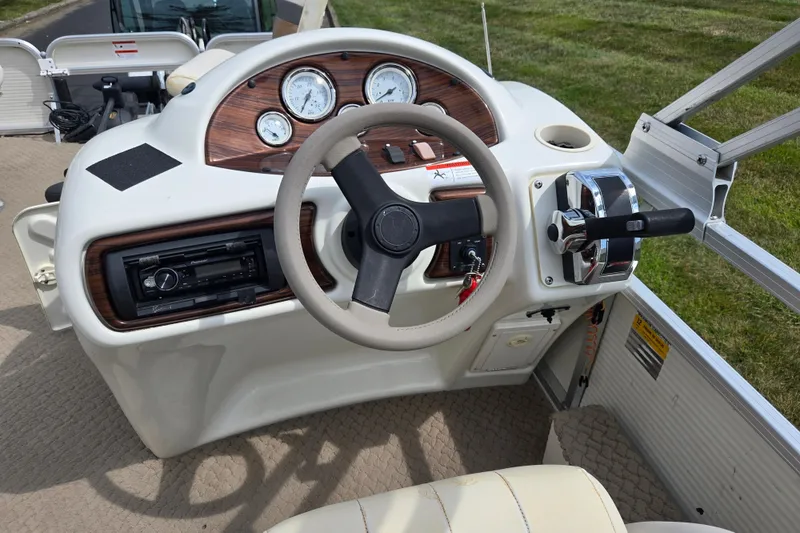 Slide: The Image of Steering console of 2007 Suncruiser Trinidad 204 boat with gauges and controls. - 24