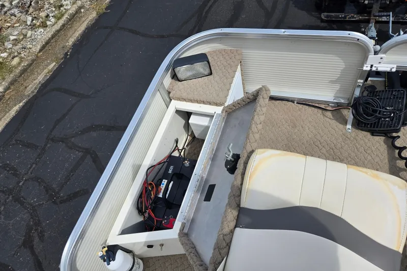 Slide: The Image of 2007 Suncruiser Trinidad 204 boat interior with storage compartment and battery. - 28
