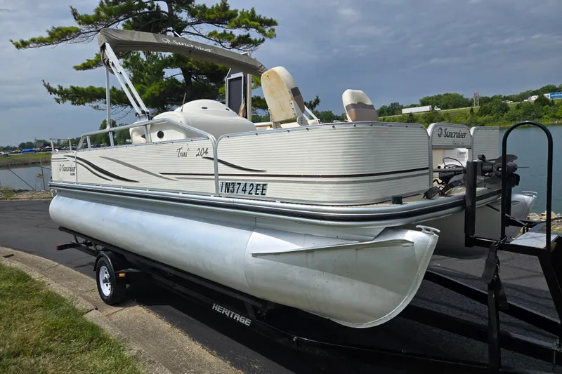 Slide: The Image of 2007 Suncruiser Trinidad 204 pontoon boat on trailer by a lake. - 8