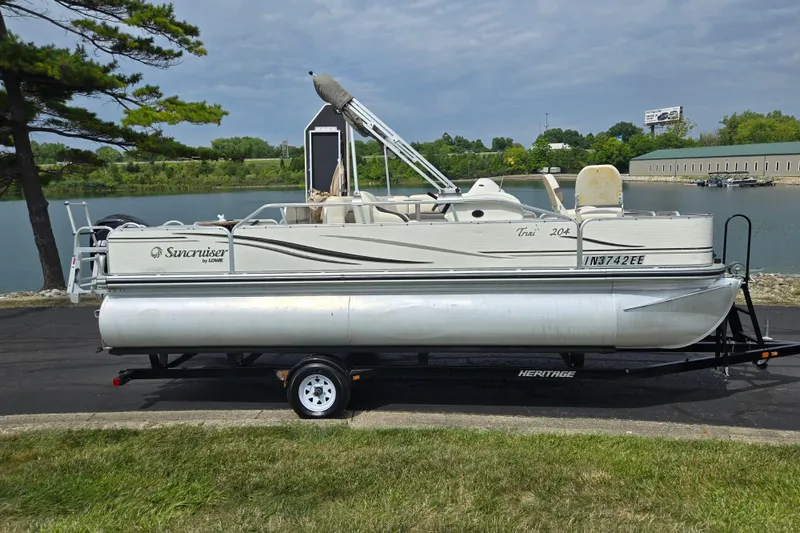 Slide: The Image of 2007 Suncruiser Trinidad 204 pontoon boat on trailer by a lake. - 9
