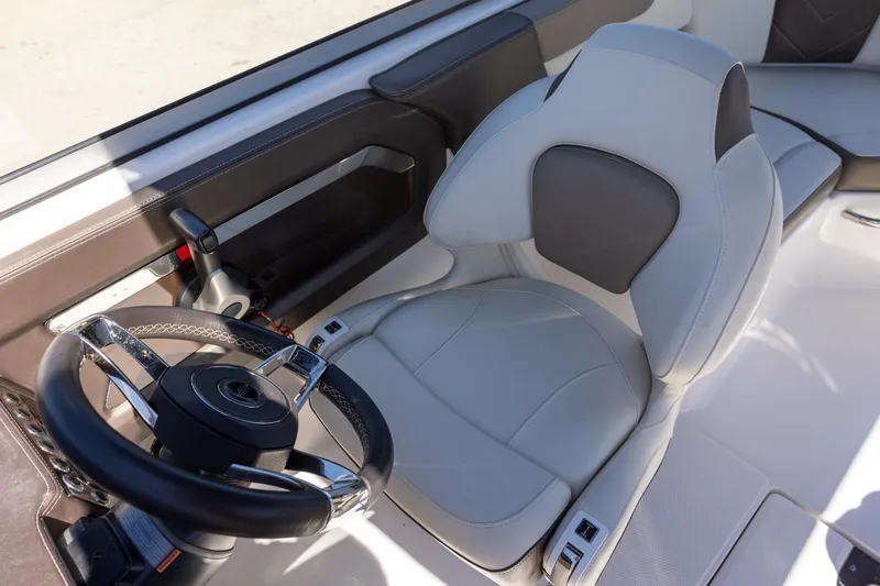 Slide: The Image of 2019 Chaparral 230 Suncoast boat interior with steering wheel and captain's seat. - 11