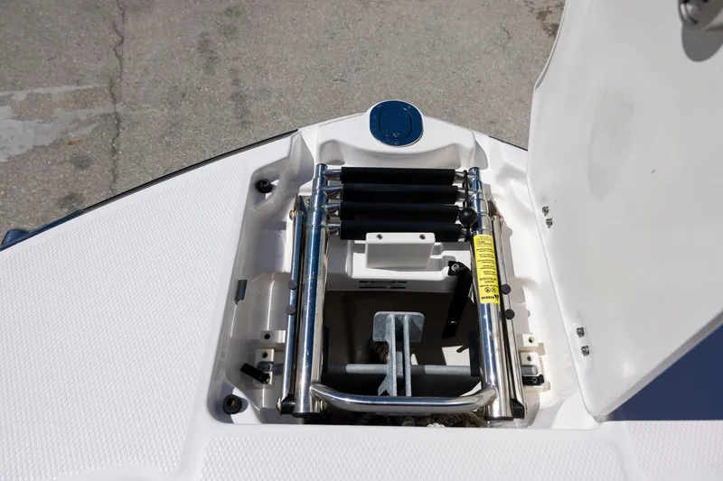 Slide: The Image of 2019 Chaparral 230 Suncoast boat anchor storage compartment with ladder. - 14