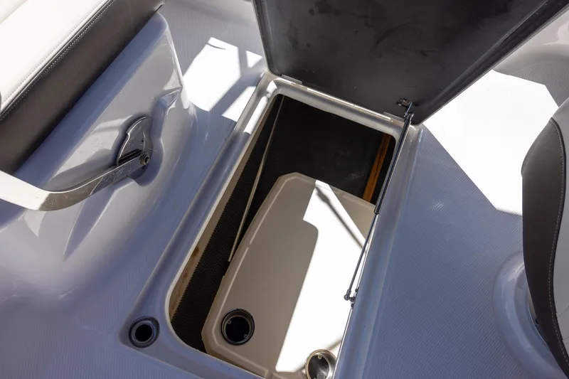 Slide: The Image of Storage compartment in 2019 Chaparral 230 Suncoast boat, featuring sleek design and practical functionality. - 18
