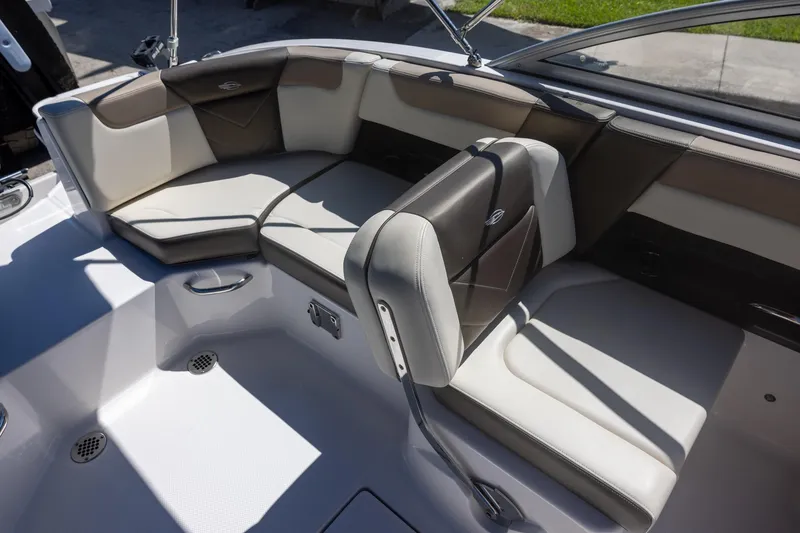 Slide: The Image of 2019 Chaparral 230 Suncoast boat interior with cushioned seating and sleek design. - 9