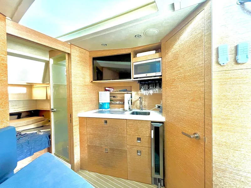 Slide: The Image of Luxurious 2020 Scout 530 LXF yacht interior with modern kitchenette and wood finish. - 10