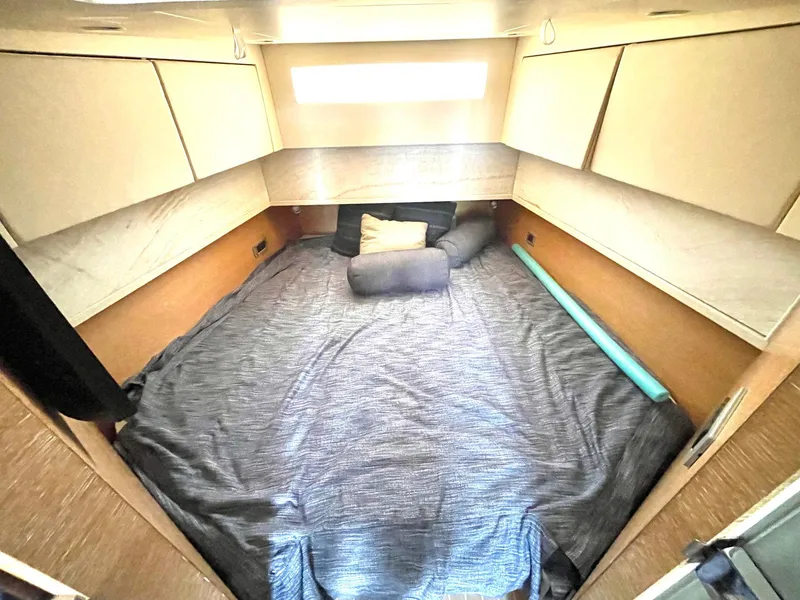 Slide: The Image of 2020 Scout 530 LXF cabin interior with cozy bed and storage cabinets. - 11