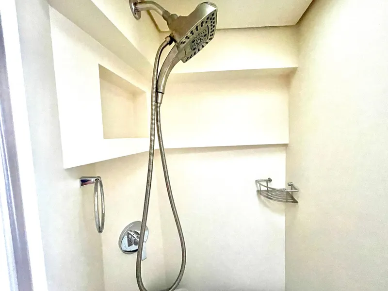 Slide: The Image of Shower area in 2020 Scout 530 LXF boat, featuring modern fixtures and shelving. - 13