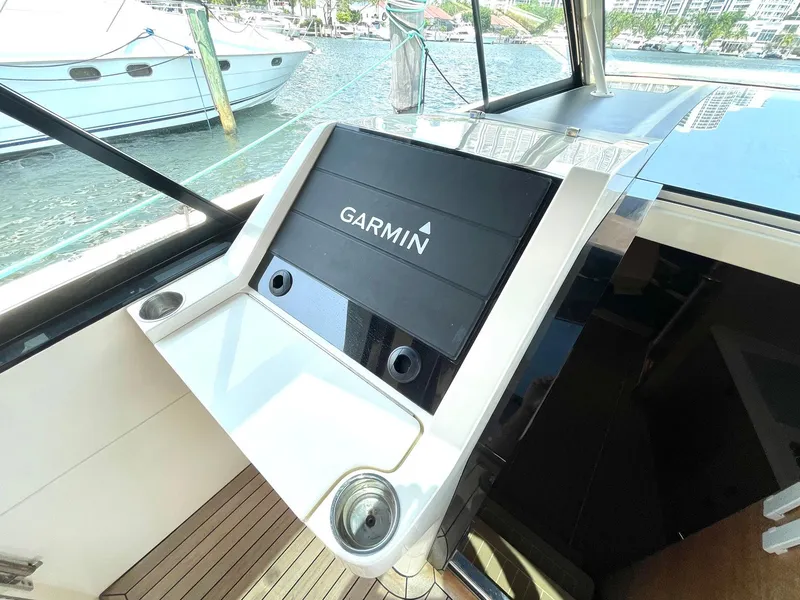 Slide: The Image of 2020 Scout 530 LXF boat with Garmin navigation system, docked by the water. - 16