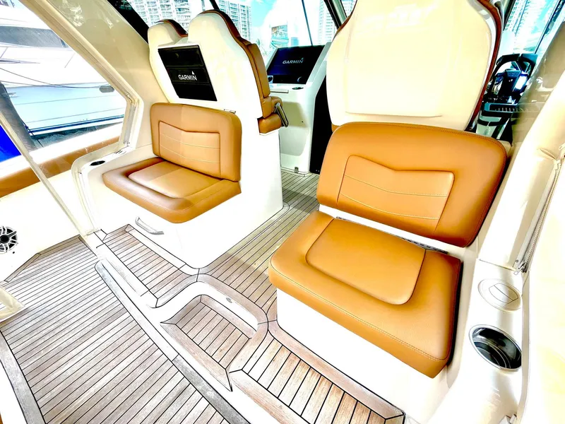 Slide: The Image of Luxurious interior seating of 2020 Scout 530 LXF boat with brown leather and wood flooring. - 22