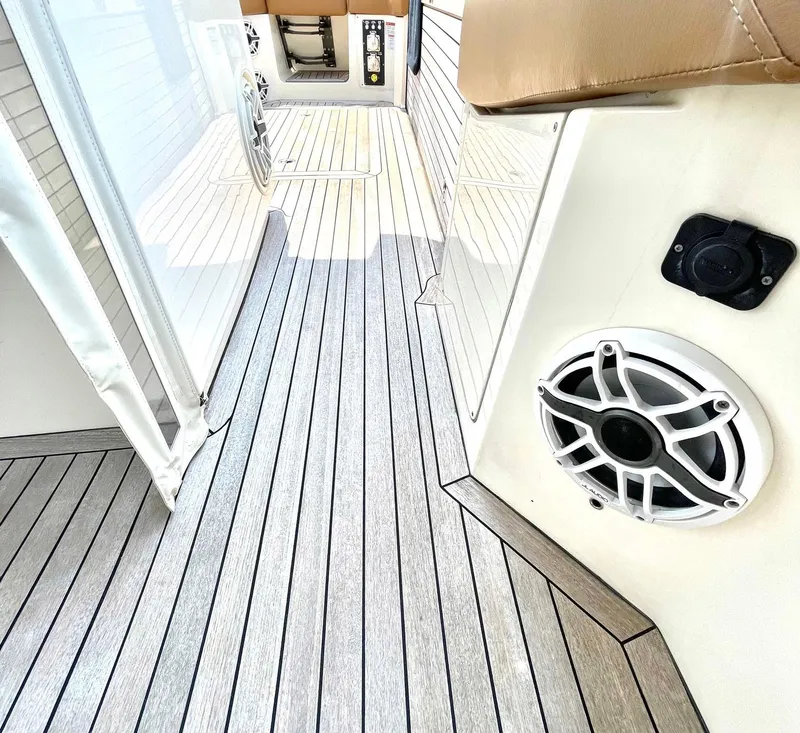 Slide: The Image of 2020 Scout 530 LXF boat interior with sleek wood flooring and built-in speaker. - 23