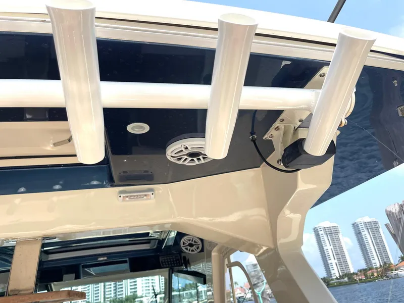 Slide: The Image of 2020 Scout 530 LXF boat with rod holders and speakers, docked near waterfront buildings. - 24
