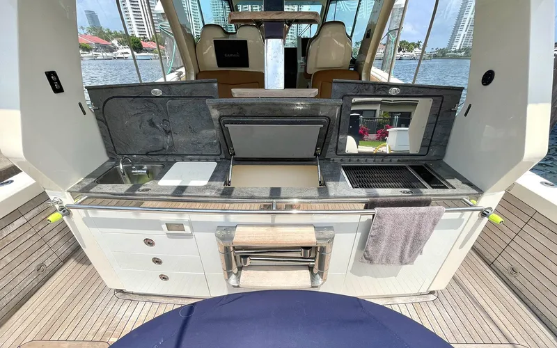 Slide: The Image of 2020 Scout 530 LXF yacht with outdoor kitchen and scenic waterfront view. - 26