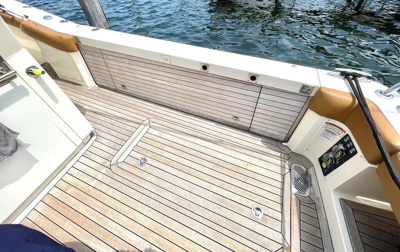 Slide: The Image of 2020 Scout 530 LXF boat deck with teak flooring and water view. - 30