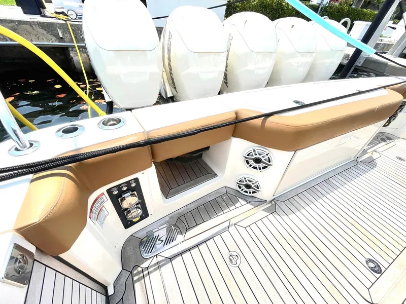 Slide: The Image of 2020 Scout 530 LXF boat deck with seating, speakers, and outboard engines. - 31