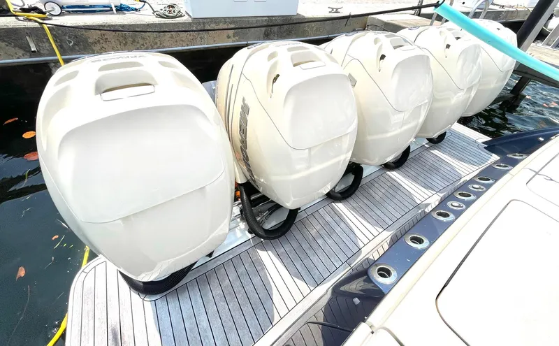 Slide: The Image of Five powerful outboard engines on a 2020 Scout 530 LXF boat docked at a marina. - 32