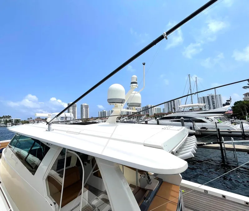Slide: The Image of 2020 Scout 530 LXF yacht docked at marina under clear blue sky. - 5