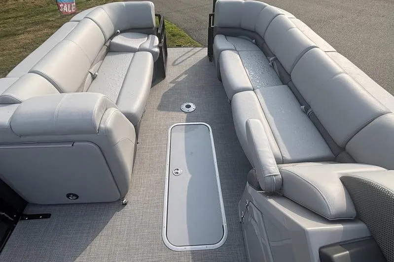 Slide: The Image of 2025 Regency 250 DL3 pontoon boat interior with gray seating and deck. - 11