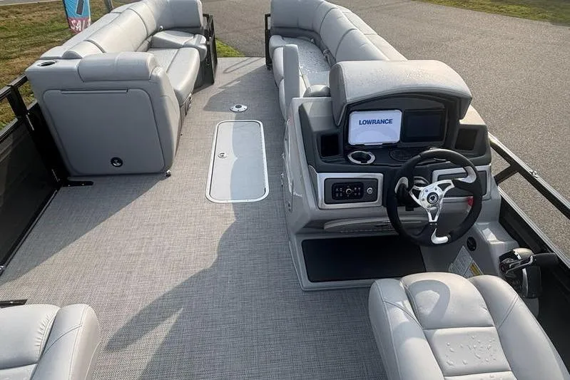 Slide: The Image of Luxurious 2025 Regency 250 DL3 pontoon boat interior with plush seating and modern dashboard. - 14