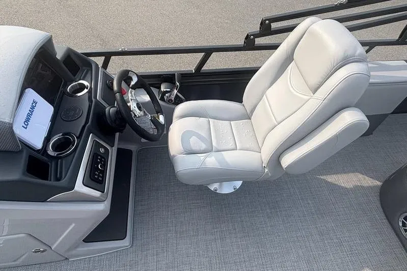 Slide: The Image of 2025 Regency 250 DL3 boat cockpit with steering wheel and plush captain's chair. - 4