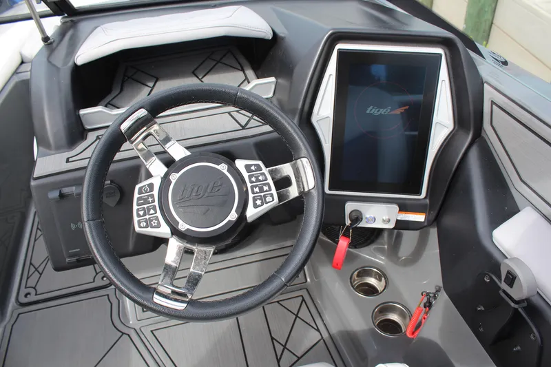 Slide: The Image of 2022 Tigé Z3 boat dashboard with steering wheel and touchscreen display. - 13