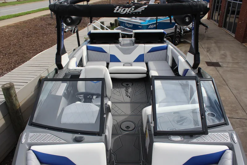 Slide: The Image of 2022 Tigé Z3 boat interior with blue and white seating, open windshield, and sleek design. - 14