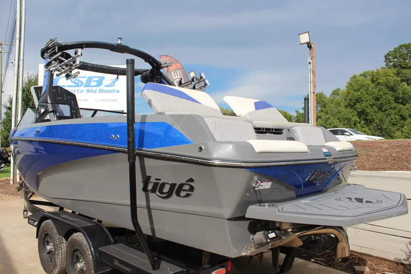 Slide: The Image of 2022 Tigé Z3 boat with blue and gray design on a trailer, parked outdoors. - 5