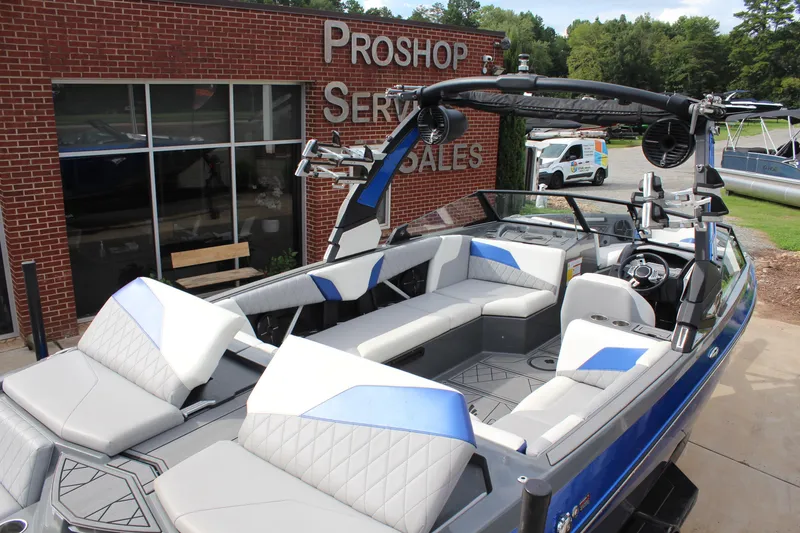 Slide: The Image of 2022 Tigé Z3 boat with sleek interior at a pro shop service and sales location. - 8