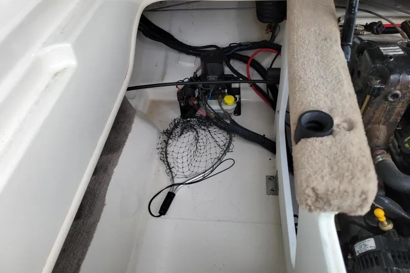 Slide: The Image of 2006 Sea Ray 205 Sport boat interior with yellow and gray seating. - 13