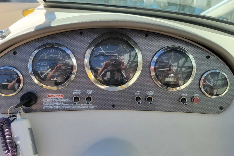 Slide: The Image of Dashboard of a 2006 Sea Ray 205 Sport boat with gauges and controls. - 16