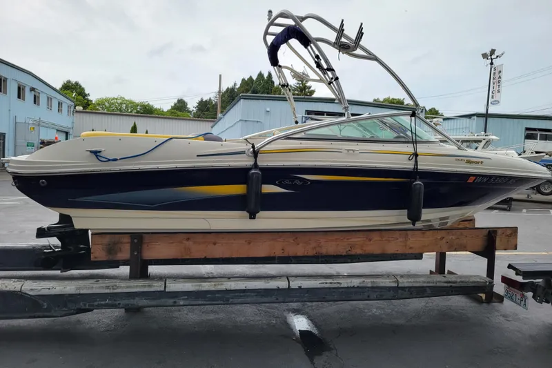 Slide: The Image of 2006 Sea Ray 205 Sport boat docked at marina, featuring sleek design and comfortable seating. - 4