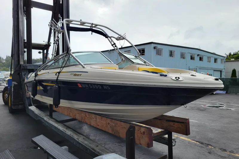 Slide: The Image of 2006 Sea Ray 205 Sport boat docked at marina, sunny day, blue ropes visible. - 5