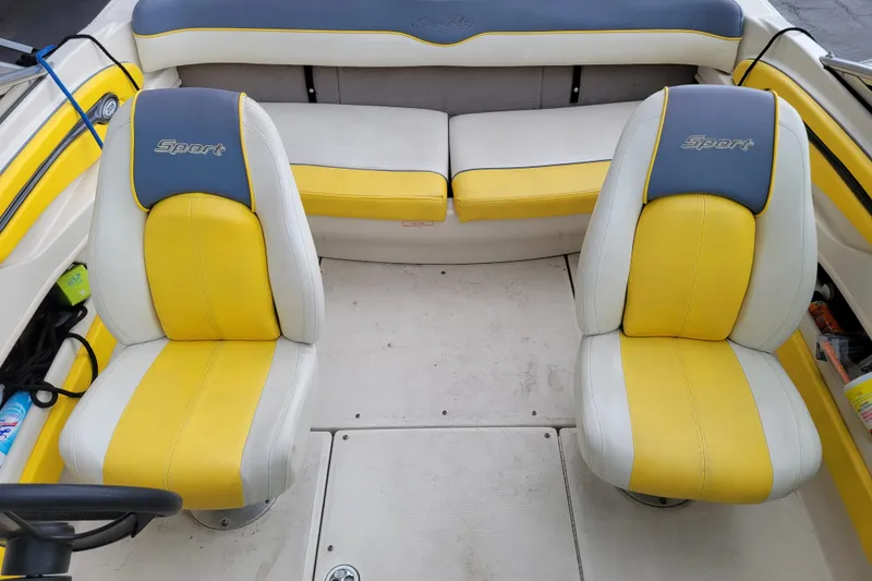 Slide: The Image of 2006 Sea Ray 205 Sport boat in storage, featuring blue and yellow accents. - 8