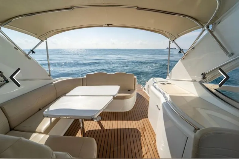 Slide: The Image of 2011 Formula 400 Super Sport yacht interior with ocean view, featuring elegant seating and table. - 13