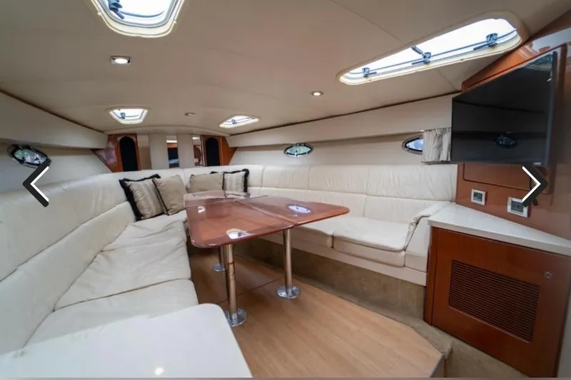 Slide: The Image of Interior of 2011 Formula 400 Super Sport yacht with plush seating and wooden table. - 17
