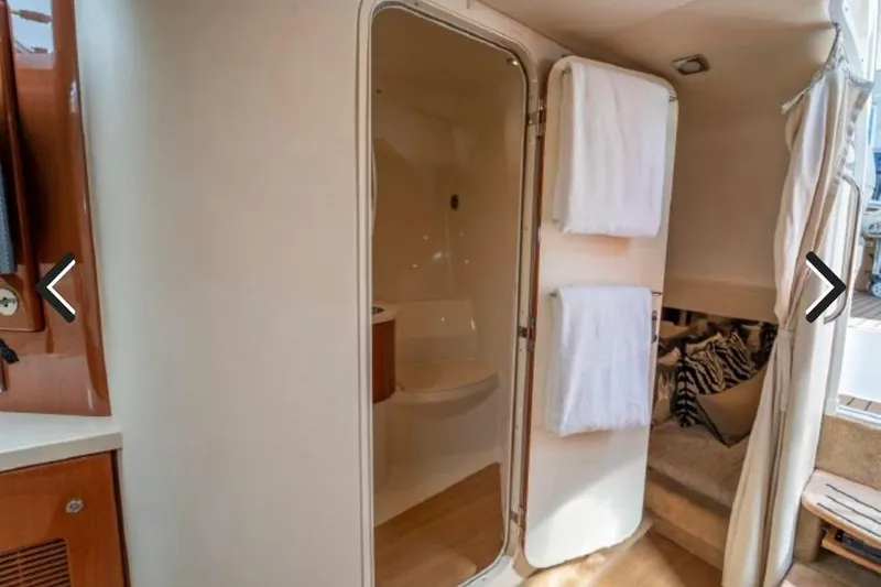 Slide: The Image of Interior of 2011 Formula 400 Super Sport yacht, featuring a bathroom and cozy seating area. - 22