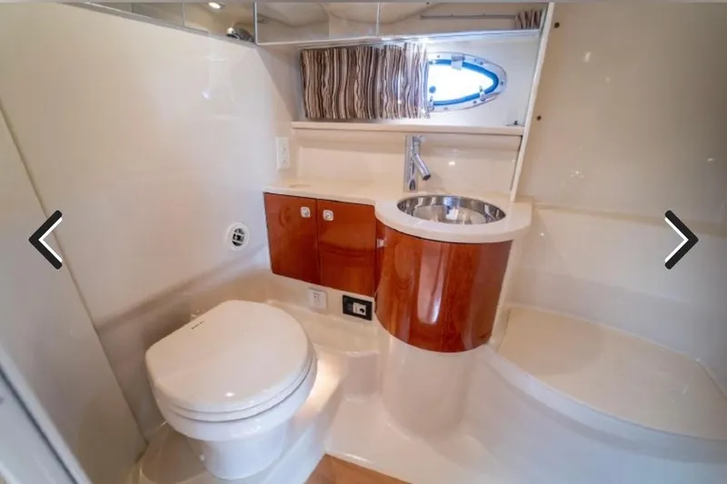 Slide: The Image of Luxurious bathroom in 2011 Formula 400 Super Sport yacht with modern fixtures and wood accents. - 24