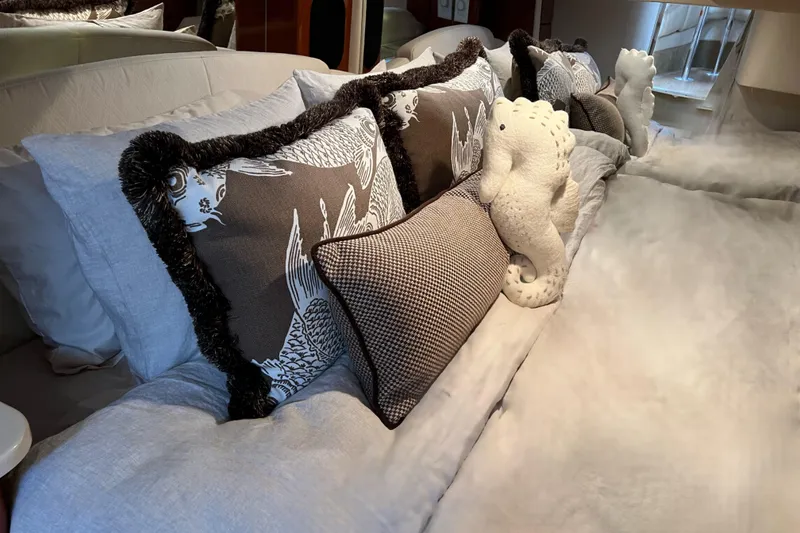 Slide: The Image of Luxurious bedding with decorative pillows and plush seahorse on a Formula 400 Super Sport yacht. - 25