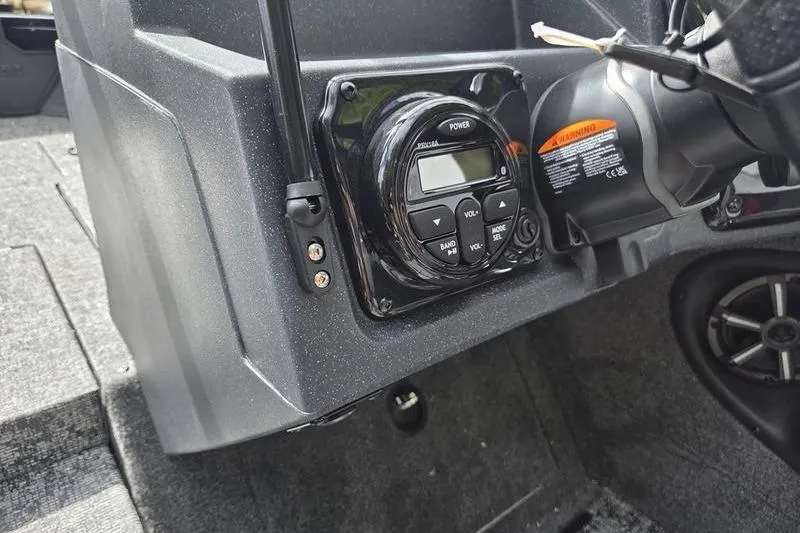 Slide: The Image of 2026 Tracker Targa™ V-19 WT boat dashboard with control panel and speaker. - 10