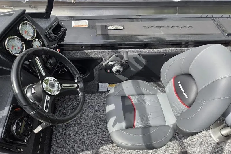 Slide: The Image of 2026 Tracker Targa™ V-19 WT boat interior with steering wheel and gray seat. - 11