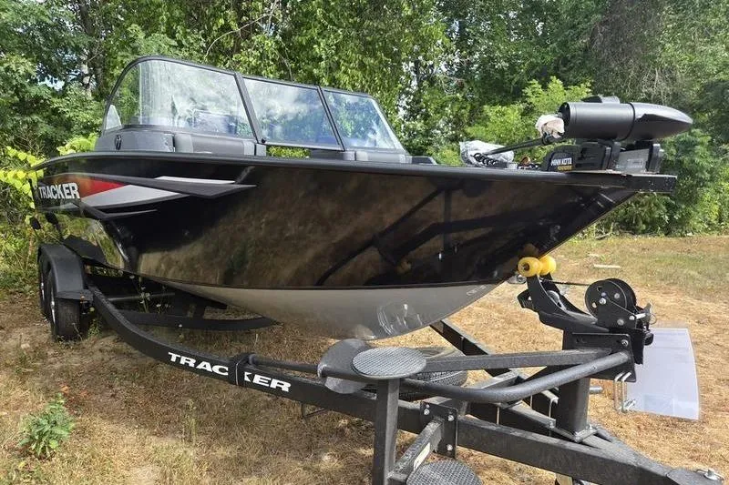 Slide: The Image of 2026 Tracker Targa™ V-19 WT boat on trailer, surrounded by greenery. - 13