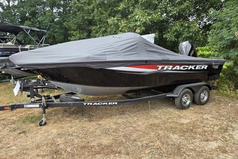 Slide: The Image of 2026 Tracker Targa™ V-19 WT boat covered on trailer, parked outdoors. - 5