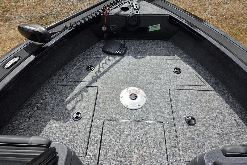 Slide: The Image of 2026 Tracker Targa™ V-19 WT boat interior with carpeted deck and storage compartments. - 6