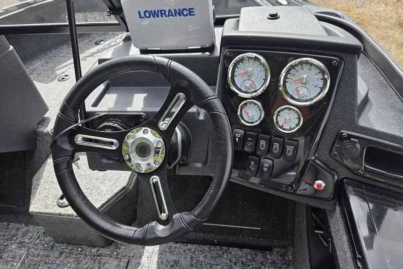 Slide: The Image of Steering wheel and dashboard of 2026 Tracker Targa™ V-19 WT boat with gauges and controls. - 9